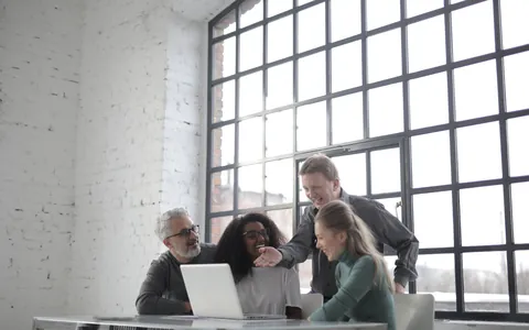 Startup team working together around a laptop