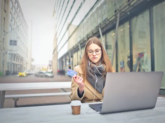 Woman paying online with a bank card on her laptop