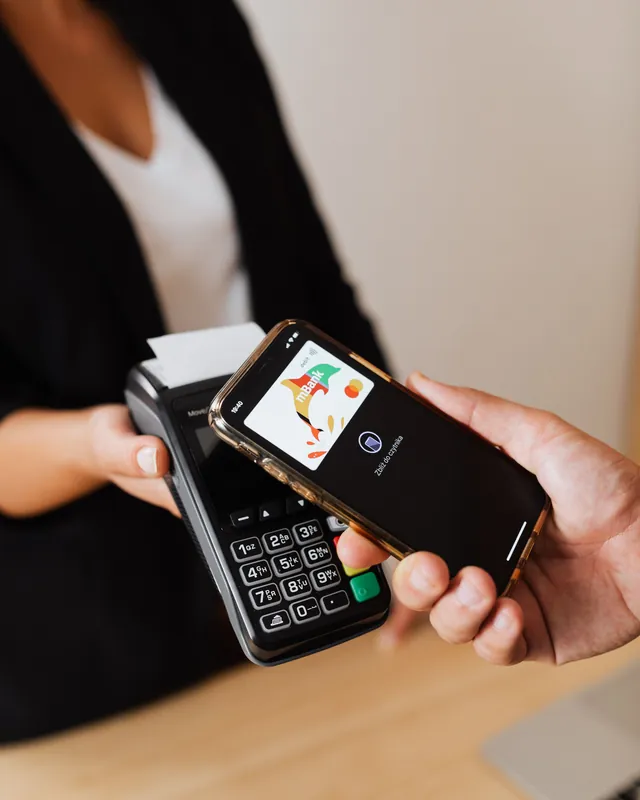 Customer paying with a smartphone at a card terminal