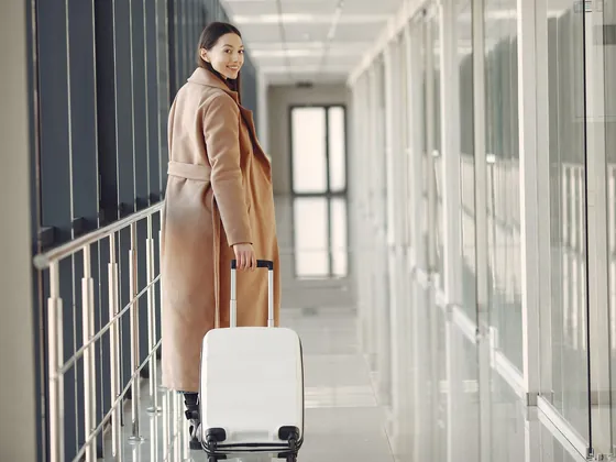 Traveller with a suitcase walking through an airport
